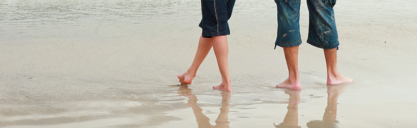 Couple walking on the beach showing legs only Couple_walking _on_a_beach