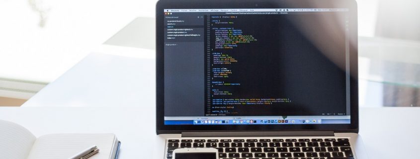 Laptop on a desk showing data accuracy and data entry code