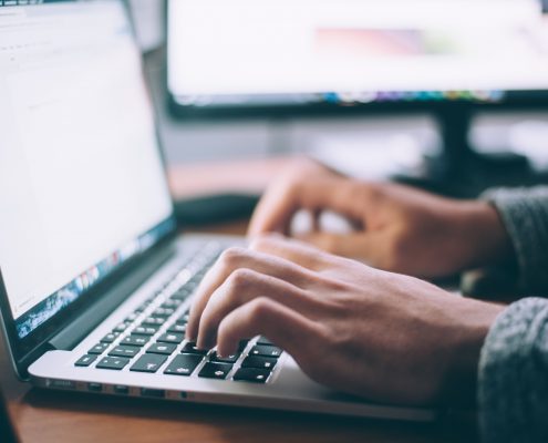 Man doing data entry system implementation on a computer